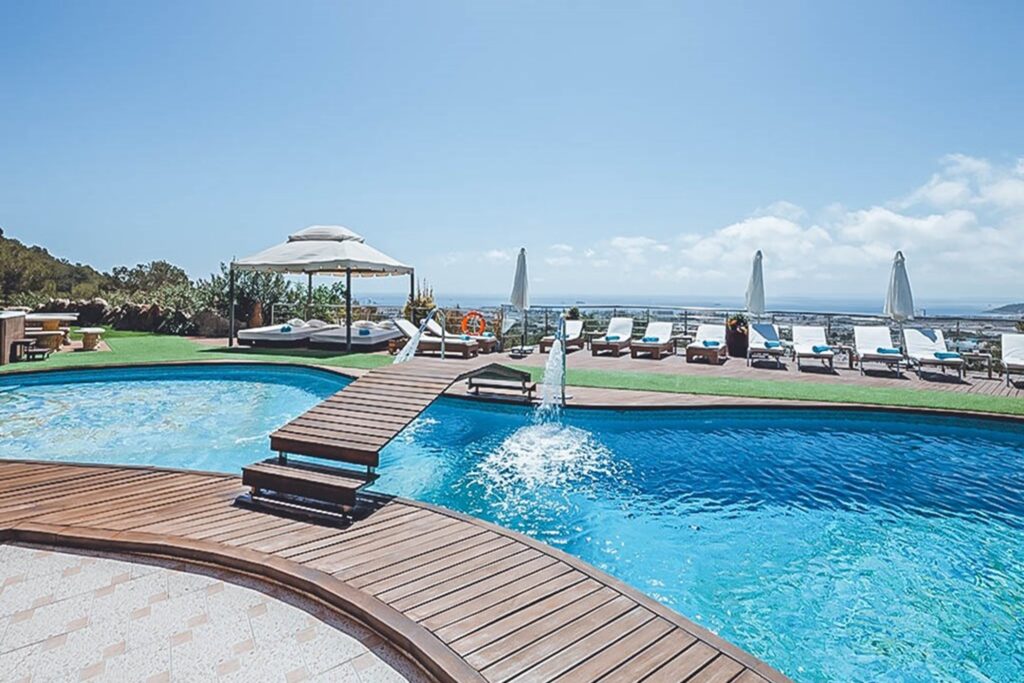 Pool area, multiple pools with loungers and coastal views at Villa Jorden in Sa Carroca, Ibiza