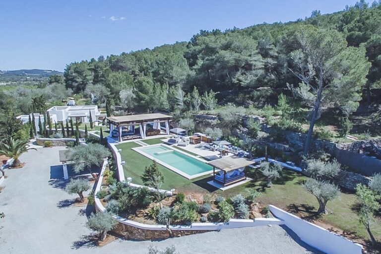 Aerial view, villa with pool surrounded by pine forest at Casa Avila, San Juan, Ibiza