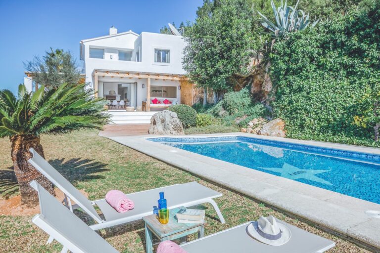 Exterior, white villa with infinity pool and palm trees at Casa Asia, San Antonio, Ibiza