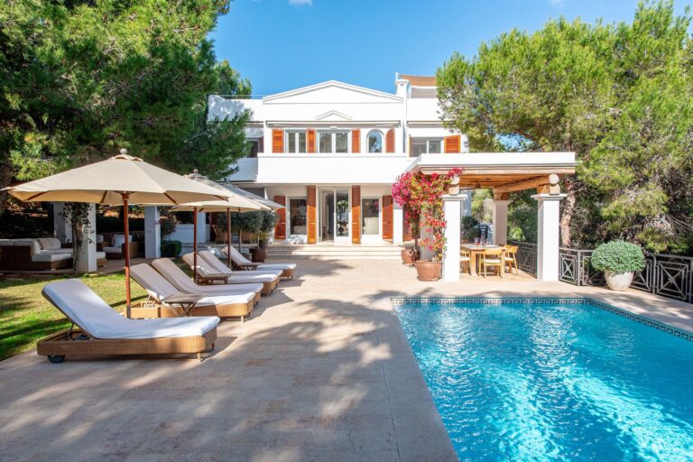Pool and terrace, white villa with red shutters, lounge chairs at Casa Azura, a luxury villa in San Josep, Ibiza