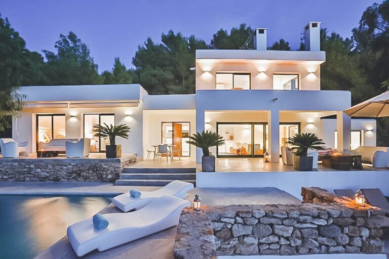 Exterior, white villa at dusk with pool and loungers at Casa Beth, San Jose, Ibiza