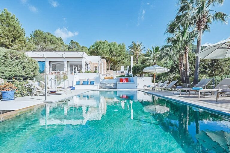 Pool with loungers and umbrellas under clear sky at Casa Brille in San Josep, Ibiza