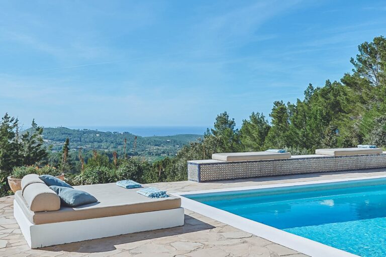 Modern lounge area with white daybed and pool overlooking at Casa Finca, holiday villa in San Juan, Ibiza