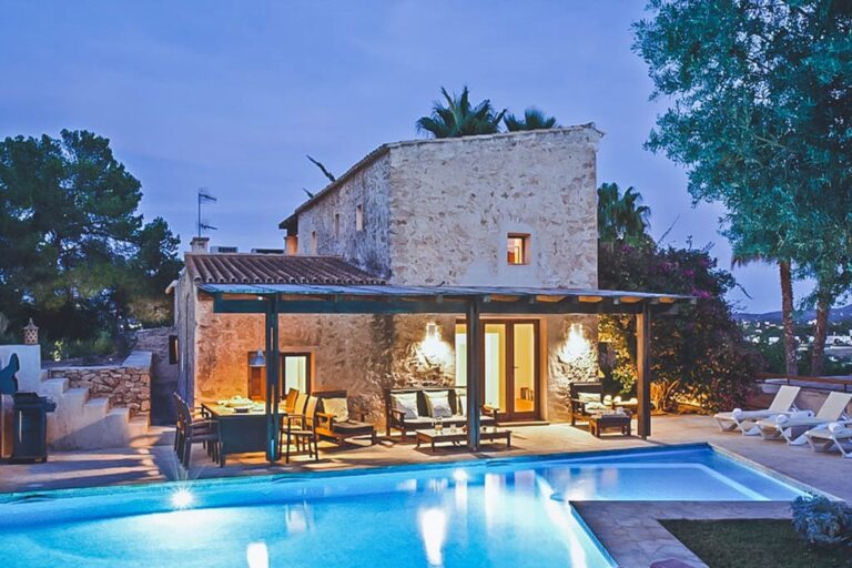 Night view, stone villa, pergola, illuminated pool lights at Casa Melania, San Jose, Ibiza