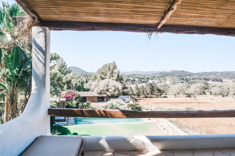 Casa Calista, Santa Eulalia del Rio, Ibiza: terrace with wooden beams overlooking pool and mountain landscape