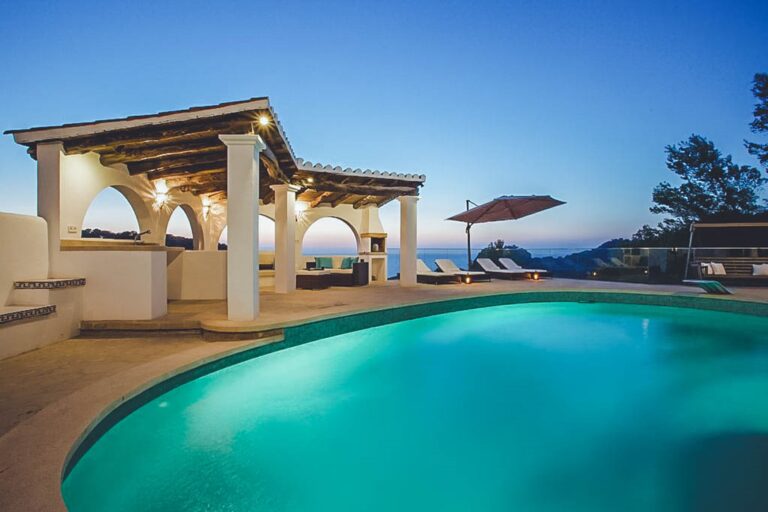 Exterior, pool area with pergola at dusk, sea view at Gie Residence, holiday villa in San Antonio, Ibiza