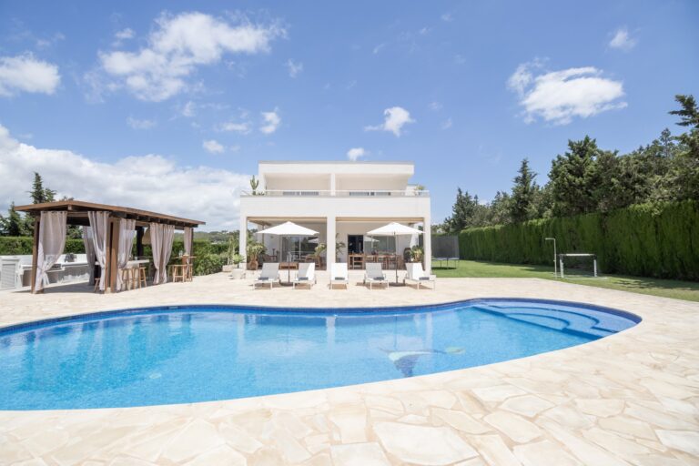 Exterior, white villa, pool, pergola and lounge seating at Sway House in Ibiza Town