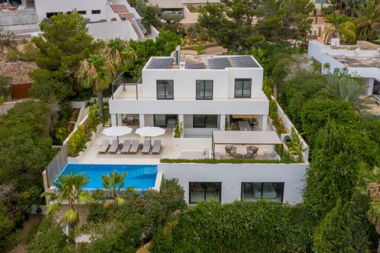 Aerial view, coastal landscape with anchored boats and white villas at Villa Panthera in Vista Alegre, Ibiza